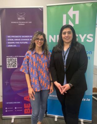 Photo of Saba and Mona in front of WITS and NexSys banners